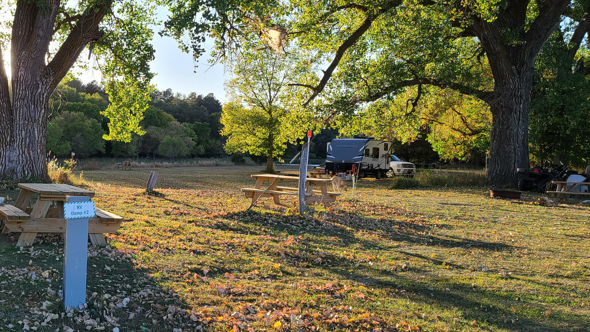 Open Camp Spot near the Niobrara River with camper in the background